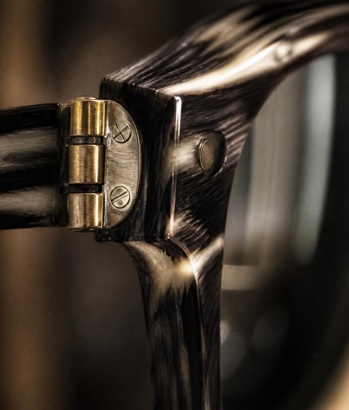Macro detail of a brass hinge on an acetate eyewear frame